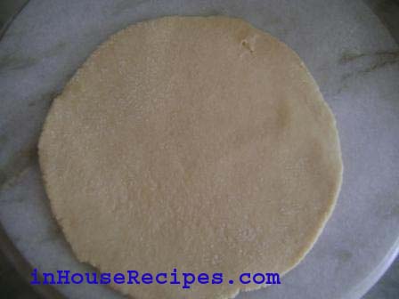 Roll it into a flat bread in a round shape